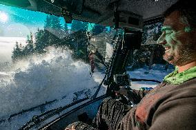 snowcat moves snow in ski resort