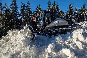 snowcat moves snow in ski resort