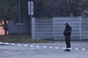 The heavily armed policeman guards the surroundings of the court