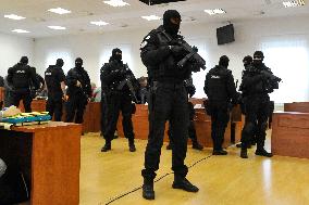 heavily armed members of Prison Service guards in a courtroom