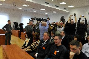 Journalist await the accused being brought into a courtroom