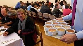 Prague archbishop dining with homeless at Christmas