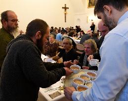 Prague archbishop dining with homeless at Christmas