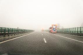 thick, heavy, dense fog, winter, European route E55, D3 motorway, road workers vehicles