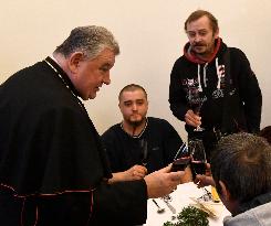 Prague archbishop Dominik Duka dining with homeless at Christmas