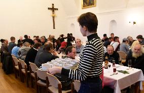 Prague archbishop dining with homeless at Christmas