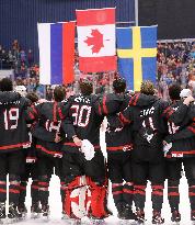 Canadian players follow the national flags of Russia, Canada and Sweden