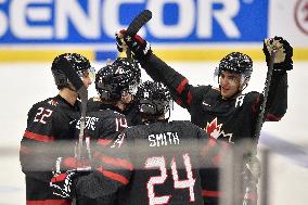 Canadian players celebrate seventh goal