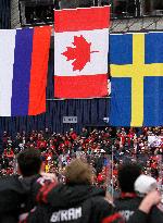 Canadian players follow the national flags of Russia, Canada and Sweden