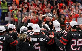 Happy Canadian players celebrate with the winner's trophy after their team won Championships