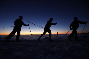 Inversion, nordic skiing, winter, snow, mountains, evening, sunset, silhouette, skier, skiers