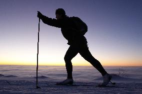 Inversion, nordic skiing, winter, snow, mountains, evening, sunset, silhouette, skier