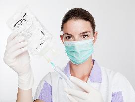 health care, nurse, nursing sister, woman, facecloth, mouth protection, syringe, saline, injection