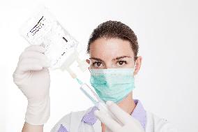 health care, nurse, nursing sister, woman, facecloth, mouth protection, syringe, saline, injection