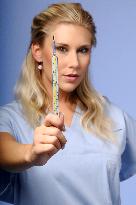 Blond nurse with the thermometer