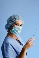 nurse with a medical cap, mask, stethoscope and injection