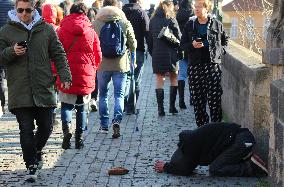 A beggar on the Charles Bridge