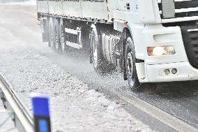 truck is slowly moving along the snow-covered D8 highway, motorway