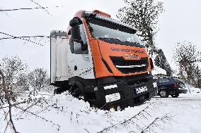 a stranded truck on a snow covered road