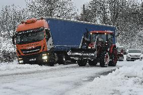 a stranded truck on a snow covered road