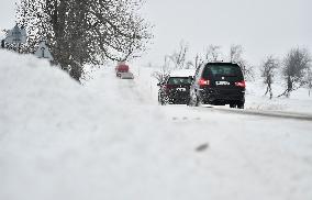 vehicles on a snow covered road, cars