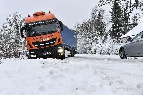 a stranded truck on a snow covered road