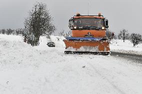 snowplow on a snow covered road