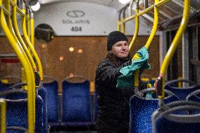 a worker disinfects a public bus against coronavirus