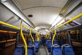 a worker disinfects a public bus against coronavirus