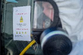 a worker with ozone disinfects a public bus against coronavirus