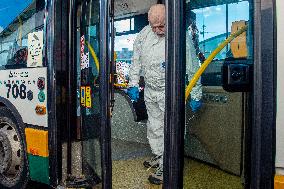 a worker with ozone disinfects a public bus against coronavirus