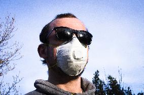 Young man, Valved Dust Mist Respirator FFP1,  Disposable Dust Mask, sun glasses