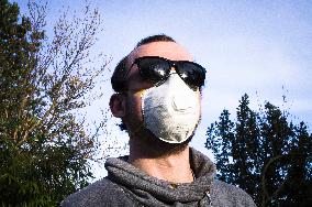 Young man, Valved Dust Mist Respirator FFP1,  Disposable Dust Mask, sun glasses