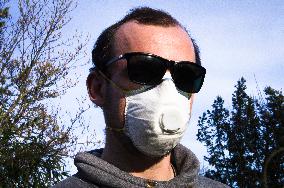 Young man, Valved Dust Mist Respirator FFP1,  Disposable Dust Mask, sun glasses