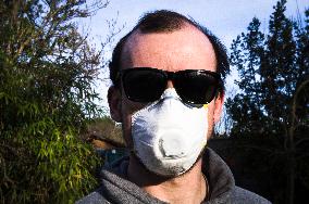 Young man, Valved Dust Mist Respirator FFP1,  Disposable Dust Mask, sun glasses