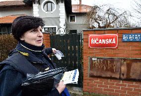 a postwoman distributes information flyers about the novel coronavirus