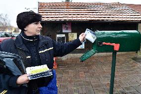 a postwoman distributes information flyers about the novel coronavirus