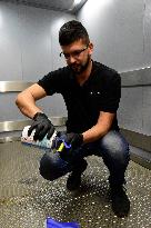 a worker disinfects public interior parts at the Gallery Santovka shopping mall against coronavirus