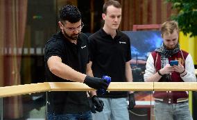 a worker disinfects public interior parts at the Gallery Santovka shopping mall against coronavirus