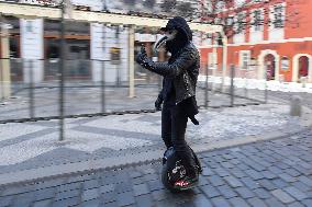 a man on a electric unicycle with plague doctor mask