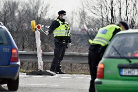 policeman, mask, control, traffic jam of trucks at the Bohumin - Chalupki crossing between Poland and the Czech Republic