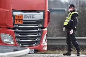 traffic jam of trucks at the Bohumin - Chalupki crossing between Poland and the Czech Republic, policeman, mask