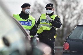 policeman, mask, control, traffic jam of trucks at the Bohumin - Chalupki crossing between Poland and the Czech Republic