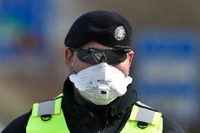 policeman, mask, control, traffic jam of trucks at the Bohumin - Chalupki crossing between Poland and the Czech Republic