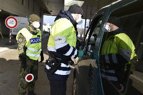 Czech soldiers help police officers guard the Mikulov-Drasenhofen border crossing