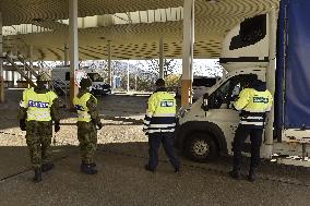 Czech soldiers help police officers guard the Mikulov-Drasenhofen border crossing