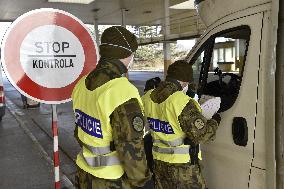Czech soldiers help police officers guard the Mikulov-Drasenhofen border crossing