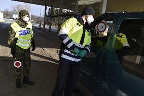 Czech soldiers help police officers guard the Mikulov-Drasenhofen border crossing