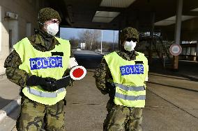 Czech soldiers help police officers guard the Mikulov-Drasenhofen border crossing
