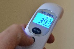 contactless medical digital thermometer, temperature measurement, symptoms, fever